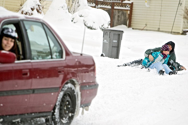 &lt;p&gt;Jayden Requena, 18, keeps an eye on her &quot;hookybobbin&quot; team that
fell off their sled while she was towing them behind her car
Friday. Evan Puskash, 15, and Faith Nelson, 10, used their snow day
away from school to their advantage by being pulled around their
Coeur d'Alene neighborhood with hot chocolate breaks between
sessions.&lt;/p&gt;