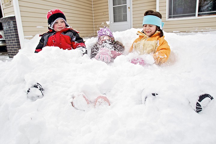 &lt;p&gt;JEROME A. POLLOS/Press Tucker Booth, 4, left, his sister, Katie Jo Booth, 6, and friend Torie Bradley, 7, get buried in the snow of the Booth's front yard in Coeur d'Alene as they try to make the most of their snow day off from school Friday.&lt;/p&gt;