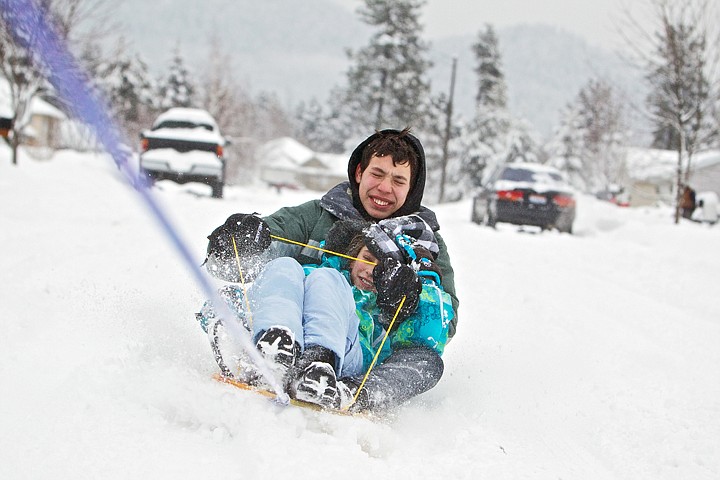 &lt;p&gt;JEROME A. POLLOS/Press Evan Puskash, 15, and Faith Nelson, 10, used their snow day away from school to their advantage by &quot;hookybobbin&quot; around their Coeur d'Alene neighborhood Friday. They had Jayden Requena, 18, tow them behind her car while they blast through the snow on their sled.&lt;/p&gt;