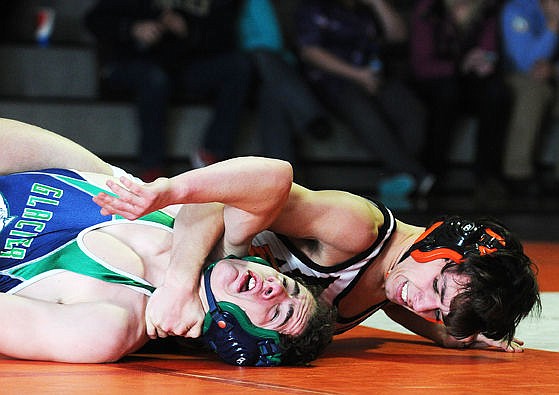 &lt;p&gt;Flathead's Payton Hume uses a claw hold as he attempts to pin Glacier's Austin Cheney during the 145-bout at the crosstown dual at Flathead on Thursday. Hume pinned Cheney in the third period to help the Braves win 62-6. (Aaric Bryan/Daily Inter Lake)&lt;/p&gt;