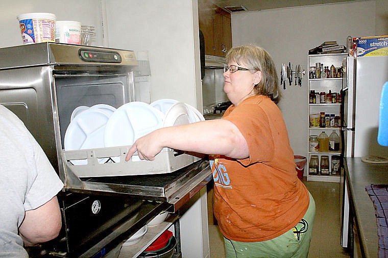 &lt;p&gt;Leslie Heppe, cook at the Superior Senior Center, pulls a tray of clean plates from the dishwasher after the center's weekly dinner.&lt;/p&gt;