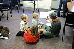 Connie Acker reads to Micah Acker, Anders Lindstrom and Summer Drey during storytime, which is held on Wednesdays at 9:30 a.m.