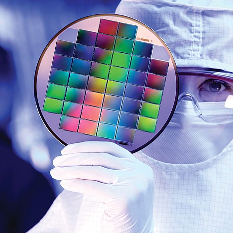 <p>An unidentified Kodak technician displays image sensors embedded on a silicon wafer at Eastman Kodak Inc., in Rochester, N.Y.</p>