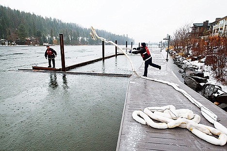 &lt;p&gt;Firefighter Tony Bajadali tosses a length of pig blanket boom to Capt. Bob Sholvald as the Coeur d'Alene Fire Department works on cleaning up a contaminant that was found in the Spokane River on Friday.&lt;/p&gt;