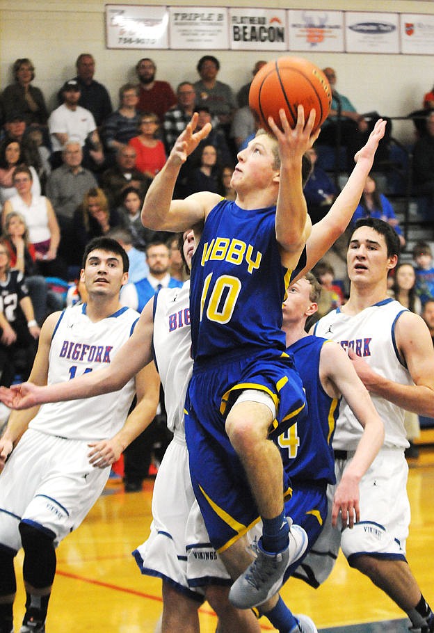 <p>Libby's Jonny Cielak goes up for a shot in a crowd of Bigfork defenders during the first quarter in Bigfork on Friday. (Aaric Bryan/Daily Inter Lake)</p>