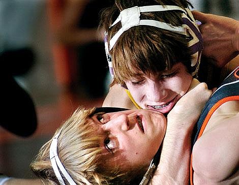 Jake Love, top, of Missoula Sentinel, applies a reverse-half nelson to Dan Jenkins, of Flathead, during their 98-pound match at Saturday afternoon's Class AA dual at FHS. Jenkins lost the match by technical fall, but Flathead won, 55-20. Chris Jordan/Daily Inter Lake