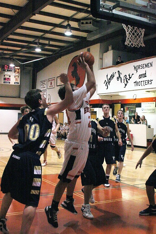 Ben Holland shot a rebound surrounded by Thompson Falls players.