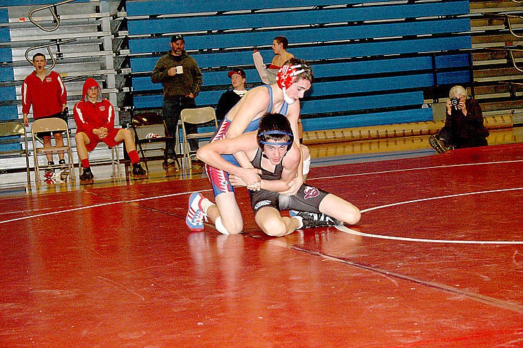 <p>Anthony Parkin grapples with a Granite player during the quad matches hosted by Superior Tuesday evening.</p>