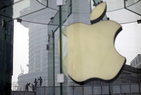 &lt;p&gt;Workers clean the rooftop of a building near an Apple Store in Shanghai, China, on July 20, 2012.&lt;/p&gt;