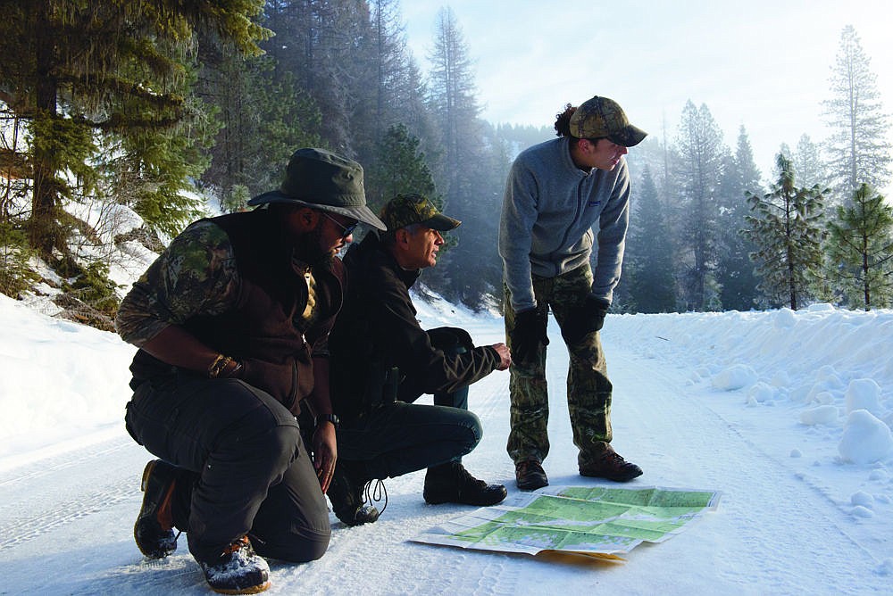 &lt;p&gt;From left to right Clarence Gilmer II, Rod Coronado and Matt Almonte of Wolf Patrol plan out their day over the weekend outside of Trout Creek.&lt;/p&gt;