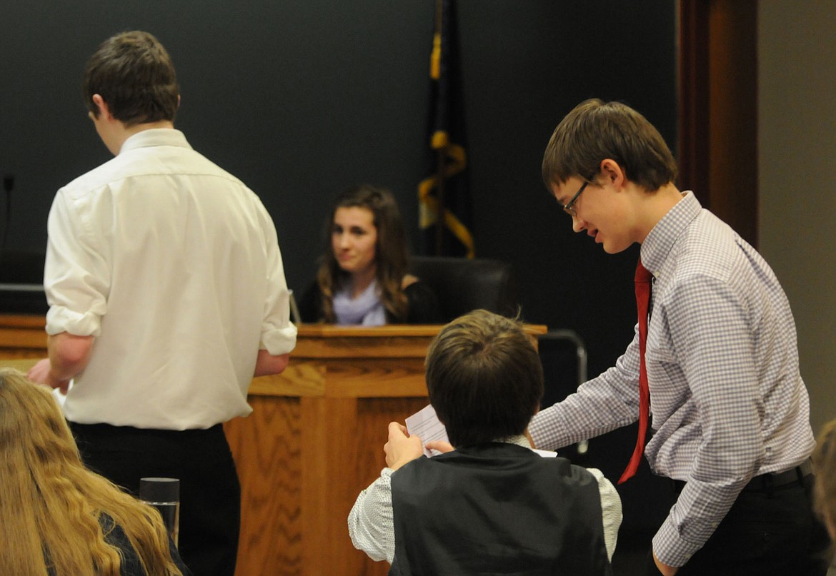 &lt;p&gt;&lt;strong&gt;Acting as attorneys&lt;/strong&gt; Stillwater Christian students Darren Kauffman, sitting, and Jake Hayden, discuss an objection with the judge as Zac Hodgskiss questions Jacina DeZell on the witness stand during a mock trial. (Aaric Bryan/Daily Inter Lake)&lt;/p&gt;