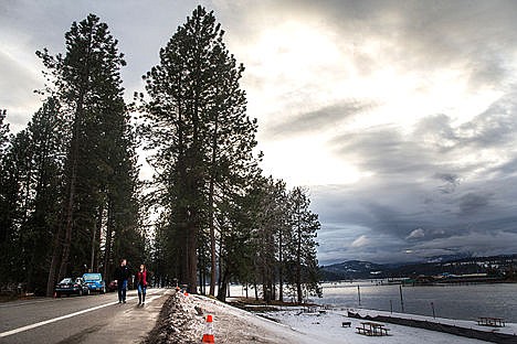 &lt;p&gt;Two people walk along the Centennial Path where Rosenberry Road turns into West River Avenue on Friday evening. The city of Coeur d'Alene and North Idaho College are negotiating how they will share the cost of work being done, which includes the removal of trees and vegetation, on the levee that runs along Rosenberry Drive and West River Avenue, commonly called &quot;the dike road.&quot;&lt;/p&gt;