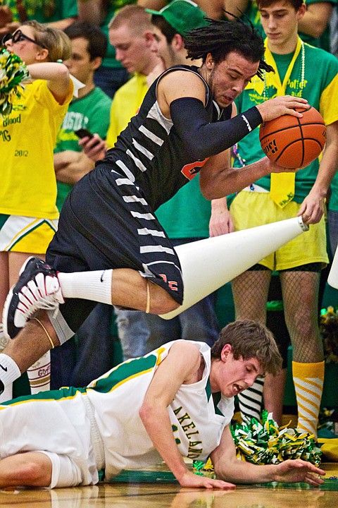 &lt;p&gt;JEROME A. POLLOS/Press Post Falls High's Marcus Colbert attempts to bounce the ball off of Tyrel Derrick from Lakeland High as he leaps over him as he falls out of bounds.&lt;/p&gt;