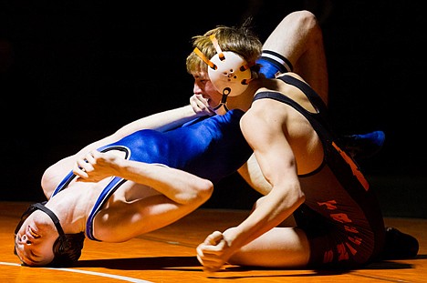 &lt;p&gt;Coeur d'Alene's Kyle White arches his back as Tannar Riekena, of Post Falls, looks for his next move during the 132-pound contest.&lt;/p&gt;