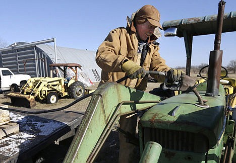 &lt;p&gt;Cattle rancher Randy Cree adds fuel to a tractor at his farm near Big Springs, Kan., on Jan. 7.&lt;/p&gt;