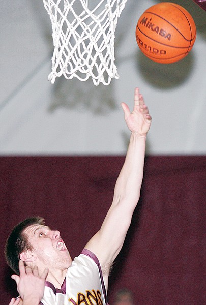 Kody Hoffman rebounds and scores on a missed Trojan free throw during the fourth quarter on Friday vs. Thompson Falls.