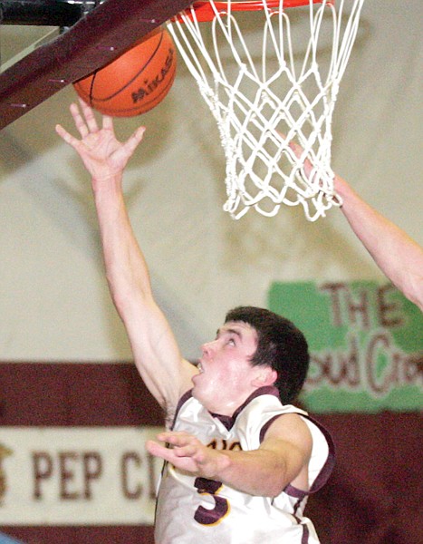 The Trojans' Cory Orr attempts a layup against Thompson Falls on Friday.