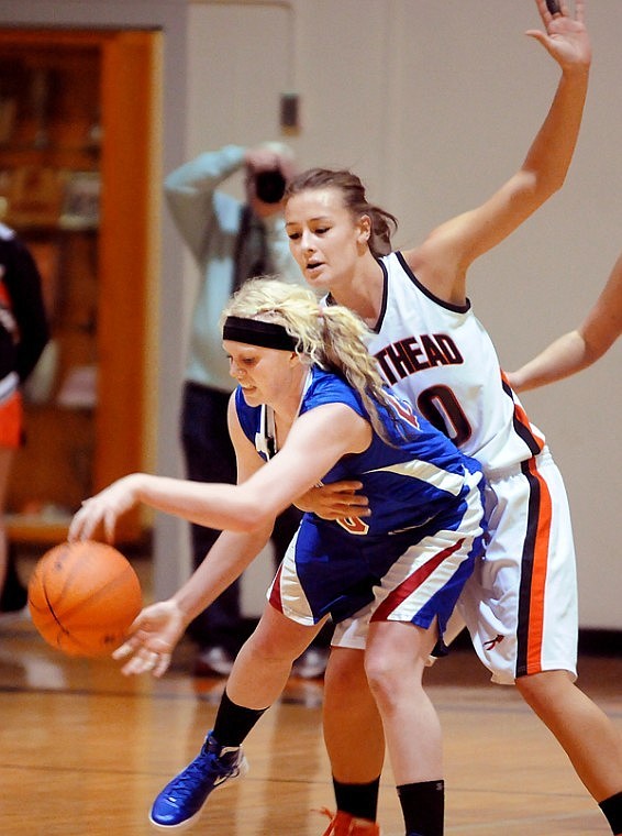 &lt;p&gt;Columbia Falls junior Hope Burlage (front) fights to hold on to
the ball as she is pressured by Flathead junior Cassie Krueger.&lt;/p&gt;