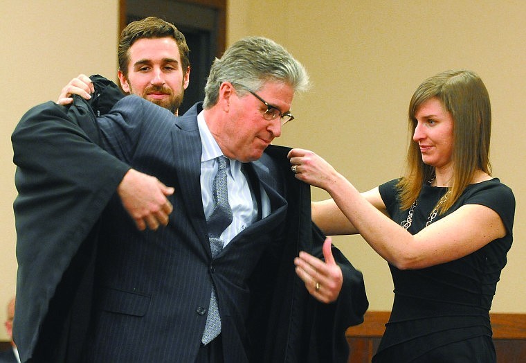 &lt;p&gt;U.S. District Judge Dana Christensen is helped into his robe by
his son, Ben, and daughter, Cassidy, after he took his oath of
office Wednesday at the Russell Smith Federal Courthouse in
Missoula. Christensen was nominated for the federal judgeship after
Judge Donald Molloy announced his retirement last year.&lt;/p&gt;