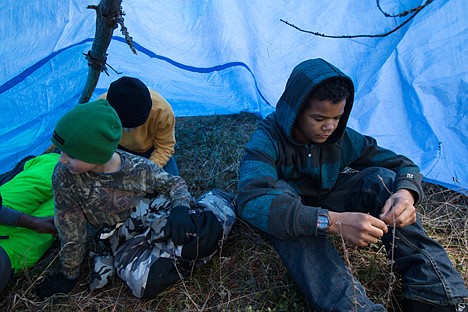 &lt;p&gt;Mighty War Chief from Coeur d&#146;Alene Boy Scout Troop 209, Morgen Reynolds, 12, sits in his team&#146;s wilderness shelter while the troop waits for judges to critique the team&#146;s shelter building ability Saturday during the Klondike Derby.&lt;/p&gt;