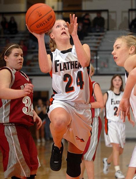 Flathead&#146;s Ashley Younkin (24) drives the lane past Helena&#146;s Alex May-Fraser during second-quarter action at Flathead on Friday night. Flathead&#146;s Kaylyn Heaton, right, seals off a defender. Garrett Cheen/Daily Inter Lake