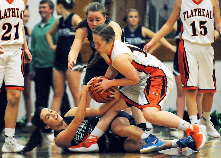 &lt;p&gt;Glacier's Hailey Ruggles fights with Flathead's Kylee Meredith for a loose ball as Hailee Bennett looks on during the first half of the Wolfpack's 59-36 crosstown victory at Flathead on Tuesday. (Aaric Bryan/Daily Inter Lake)&lt;/p&gt;