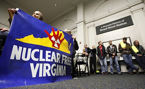 &lt;p&gt;Protesters hold a sign during a meeting of the Virginia Uranium Mining Working Group final informational public hearing at the Science Museum of Virginia in Richmond, Va., on Nov. 27, 2012.&lt;/p&gt;