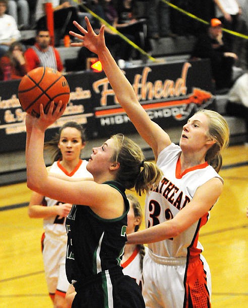 <p>Glacier's Anna Shrade gets past Flathead's Tiana Johnson as she puts up a shot. (Aaric Bryan/Daily Inter Lake)</p>