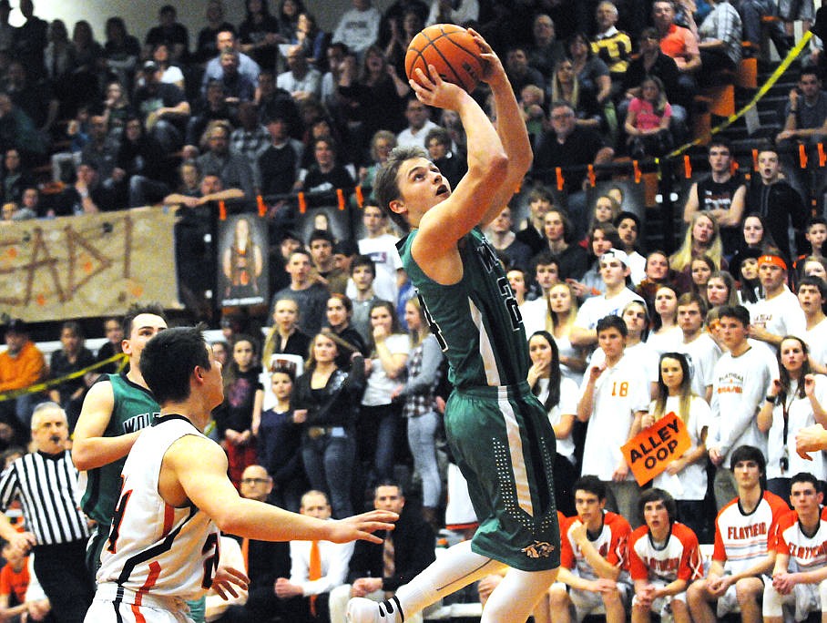 &lt;p&gt;Glacier's Tadan Gilman soars past Flathead's CJ Dugan to score a basket in the first quarter in the Wolfpack's 55-39 victory at Flathead on Tuesday. (Aaric Bryan/Daily Inter Lake)&lt;/p&gt;