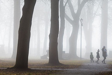 &lt;p&gt;Laura Johnson leads her children Abi, 7, center, and Liam, 3, on a walk through the Coeur d&#146;Alene City Park as a heavy fog settles in the area Monday morning.&lt;/p&gt;