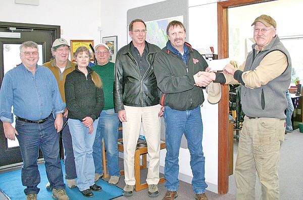 The Plum Creek Foundation awarded a $1,500 grant to the Lincoln Conservation District. From left, Darris Flanagan, LCD supervisor; Mark Romey, LCD supervisor, Susan Ennenbach, LCD chairperson; Wayne Maahs, LCD supervisor; Jim Mepham, Eureka school superintendent; Larry Benson, Lincoln County High School biology teacher/Envirothon adviser; Mark Aston, senior resource forester with Plum Creek Timber Co., in Libby.