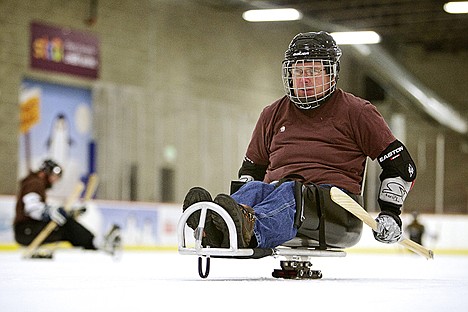 &lt;p&gt;Tom McTevia propels himself along the ice with specially-made hockey sticks that have metal cleats on the handle to help grip the ice.&lt;/p&gt;