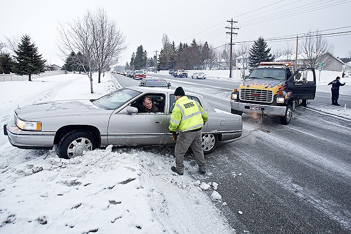 &lt;p&gt;JEROME A. POLLOS/Press John Johnson receives direction from Mike Larson from Schaffer's Towing before being pulled off of a snow bank Thursday along Ramsey Road north of Dalton Avenue. Freezing rain turned the roadway into a dangerous commute for drivers with four accidents occurring within 15 minutes of each other.&lt;/p&gt;