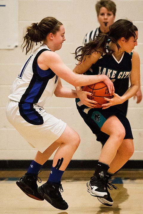 &lt;p&gt;Coeur d'Alene High School's Erin Legel gets a hold of the ball while Lake City's Alyssa Kacalek receives a pass in the first half.&lt;/p&gt;