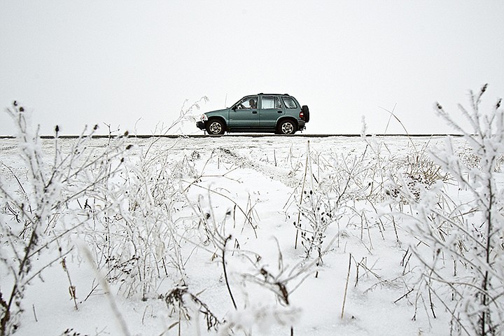 &lt;p&gt;JEROME A. POLLOS/Press A motorist travels west on Prairie Avenue near Highway 41 as fog and snow covers the landscape of the Rathdrum Prairie.&lt;/p&gt;