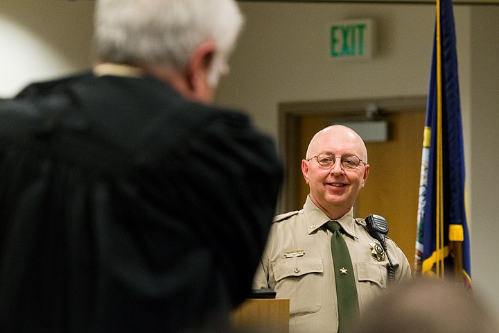 &lt;p&gt;SHAWN GUST/Press Ben Wolfinger, Kootenai County Sheriff, looks on as his father-in-law Judge Eugene Marano dons his robe Monday during a swearing-in ceremony in Coeur d'Alene.&lt;/p&gt;