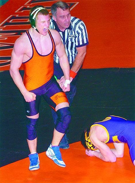 Chris Jordan/Daily Inter Lake&lt;br&gt;Flathead's David Lau screams after pinning Derrick Gerrity of Polson during Flathead's dual victory over the Pirates Thursday afternoon in Kalispell.