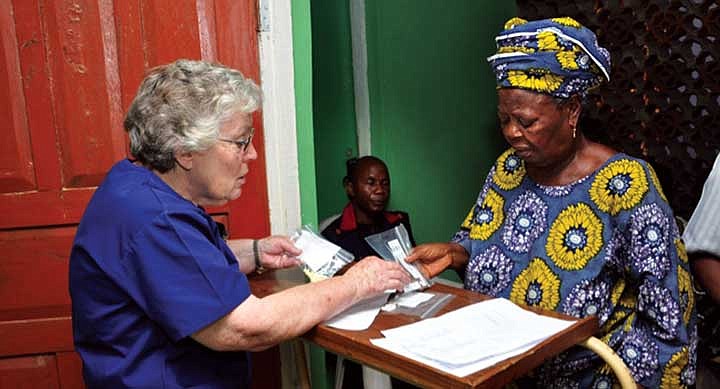 Frances Irwin, right, dispenses medication during the Moses Lake Medical Team's 2013 mission in Benin City, Nigeria.
