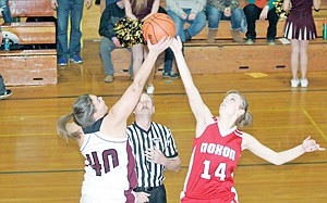 &lt;p&gt;The Lady Trojans win the opening tip with Caitlin Johnston, left, and Noxon's Zoey Osborne Saturday during Throwback Night at Troy High School.&lt;/p&gt;