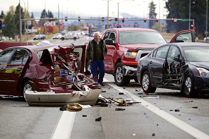 &lt;p&gt;JEROME A. POLLOS/Press Bob Grimm walks between the wreckage of a 13-car pileup Tuesday as he waits to have his truck moved from the scene on the northbound lanes of US 95 south of Kathleen Avenue in Coeur d'Alene. The accident shutdown the section of highway for more than two hours as the scene was investigated by Idaho State Police and vehicles were removed.&lt;/p&gt;