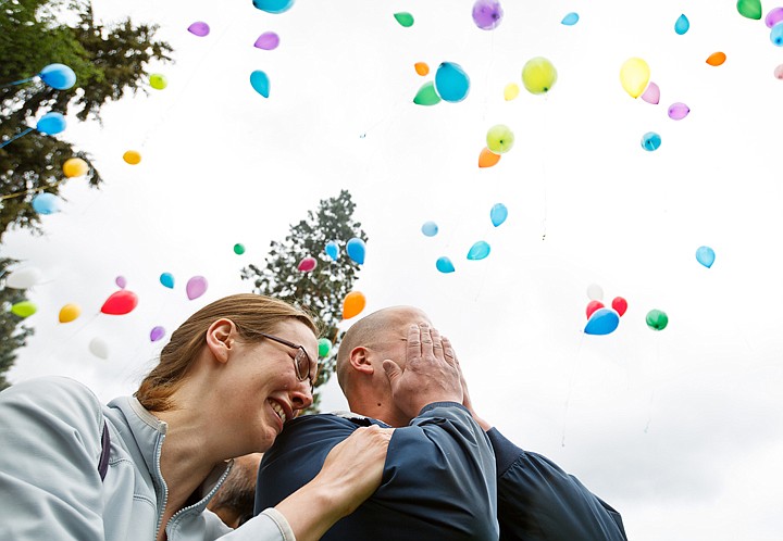 &lt;p&gt;SHAWN GUST/Press Paula and Clay Gustin are emotionally overwhelmed as dozens of balloons float above Wednesday, May 23, 2012 during a memorial at ABCD Daycare in Coeur d'Alene for their five-year-old son, Rhett, who died on Sunday.&lt;/p&gt;