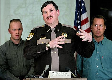 Flathead County Sheriff Mike Meehan tells the media Saturday about a 3-year-old boy whose body was found in a septic tank Friday night. Meehan is flanked by Flathead County Search and Rescue coordinator Jordan White, left, and FBI special supervisory agent Rick Rasmussen. Craig Moore photo/Daily Inter Lake