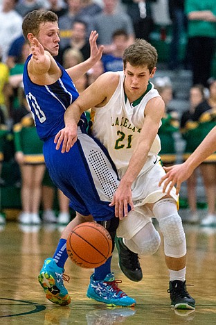 <p>Tyrel Derrick, a Lakeland guard, lays out Coeur dAlenes Austin Paulsen Tuesday night while making a break for the hoop.</p>