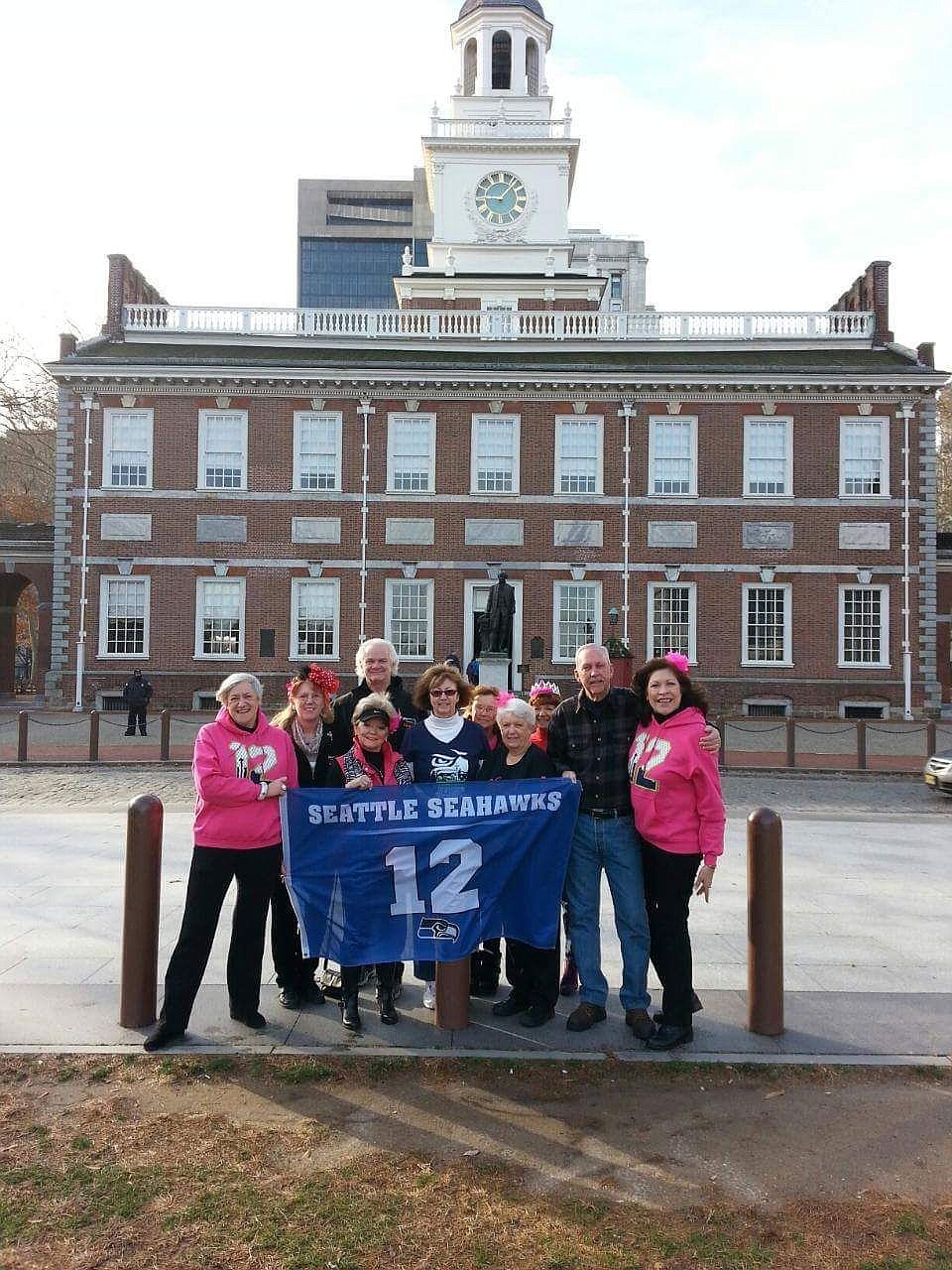 &lt;p&gt;Kay Mills of the Blazen Divaz is a die hard Seahawks fans, to the point of having custom, pink 12 Man hoodies made for the Blazen Divaz and carrying the 12 Man flag with her to Philadelphia where the Blazen Divaz performed in the Mars Old Fashioned Christmas parade on Dec. 5.&lt;/p&gt;&lt;p&gt;Kay Mills, dancer and CPA for the Blazing Divaz, is pictured in the center of the photo with the blue Seahawks jersey. She flew her son from Texas to Philly to join her in watching the Seahawks trounce the Eagles 24-17 at the December 7 game. Kay attended the decisive, nail biter game in Seattle vs the The 49ers on Jan. 19. Two days later Kay had her Super Bowl tickets in hand. She has been in Phoenix since Jan. 22, counting down the days to see the Seahawks make their historic Super Bowl repeat performance.&lt;/p&gt;&lt;p&gt;Kay's wardrobe is primarily blue and green with the SeaHawks logo, from her jewelry down to her tennis shoes. Kay attends the games with her son as her husband Steve doesn't like football.&lt;/p&gt;