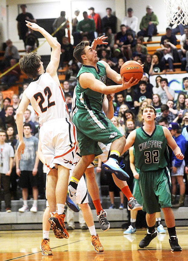 &lt;p&gt;Glacier's Tucker Rauthe sails past Flathead's Wyatt Smith for a basket during the Wolfpack's 70-40 crosstown victory in Flathead on Thursday. (Aaric Bryan/Daily Inter Lake)&lt;/p&gt;