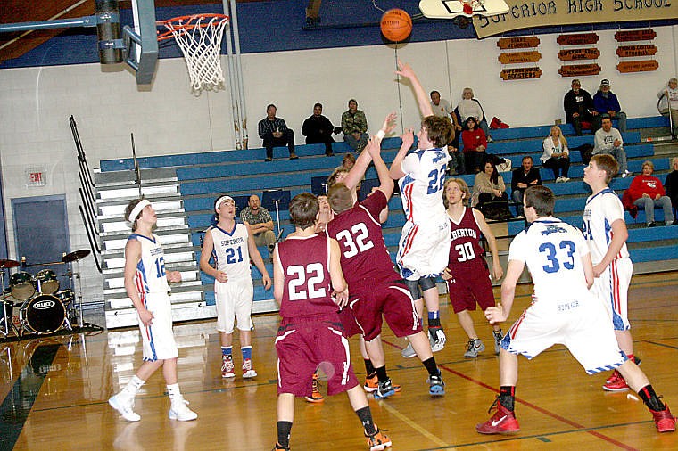 &lt;p&gt;Josh Benda takes a shot for the basket of his home gym as Troy Munsch and his fellow Albertson Panthers move to block the offense.&lt;/p&gt;