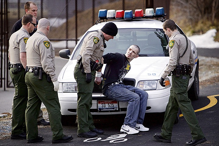 &lt;p&gt;JEROME A. POLLOS/PressKootenai County Sheriff deputies prepare to move a suspect who was arrested Wednesday February, 7 for leading three law enforcement agencies on a high-speed chase through Hayden, Dalton Gardens and Coeur d'Alene. The suspect wrecked the vehicle he was in at Hubbard Avenue and Northwest Boulevard and then led police officers on a short foot pursuit through the education corridor before being apprehended.&lt;/p&gt;