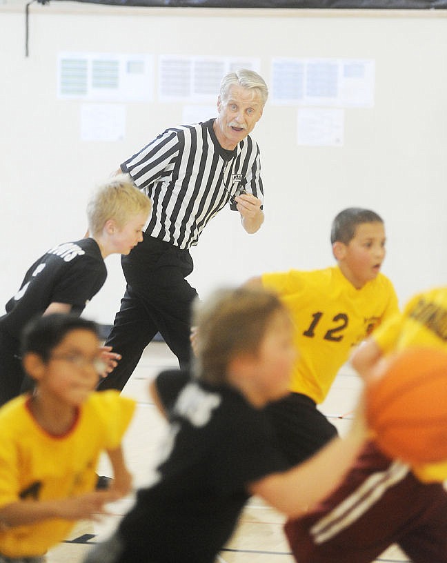 <p>Greg Carson runs up the court while refereeing a Rotary Basketball game last Saturday at The Summit. (Aaric Bryan/Daily Inter Lake)</p>
