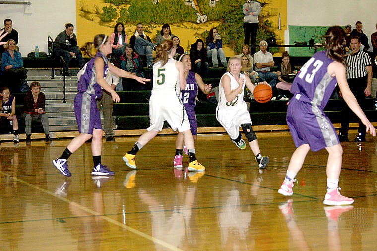 &lt;p&gt;Pilar Cantrell-Field weaves around the Charlo defense as Gabby Moeller keeps the way open for her to reach the St. Regis net.&lt;/p&gt;