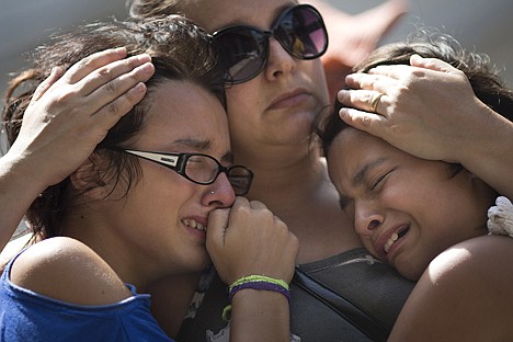 &lt;p&gt;Girls cry in front of a makeshift memorial outside the Kiss nightclub where a fire killed more than 230 people in Santa Maria, Brazil, Tuesday. The repercussions of a tragic nightclub fire in southern Brazil widened Tuesday as mayors around the country cracked down on such venues in their own cities and investigators searched two other nightspots owned by a partner in the club that caught ablaze. Most of the dead were college students 18 to 21 years old, but they also included some minors.&lt;/p&gt;